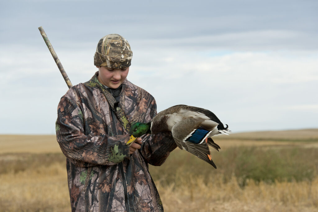 A young duck hunter with a Drake Mallard in Norh Dakota