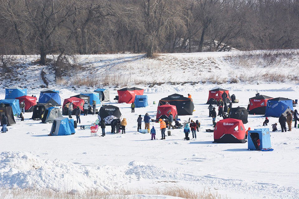 Families ice fishing on Heitkamp Pond during the fishing derby